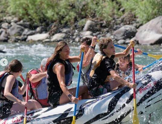 Family Having Fun While Rafting